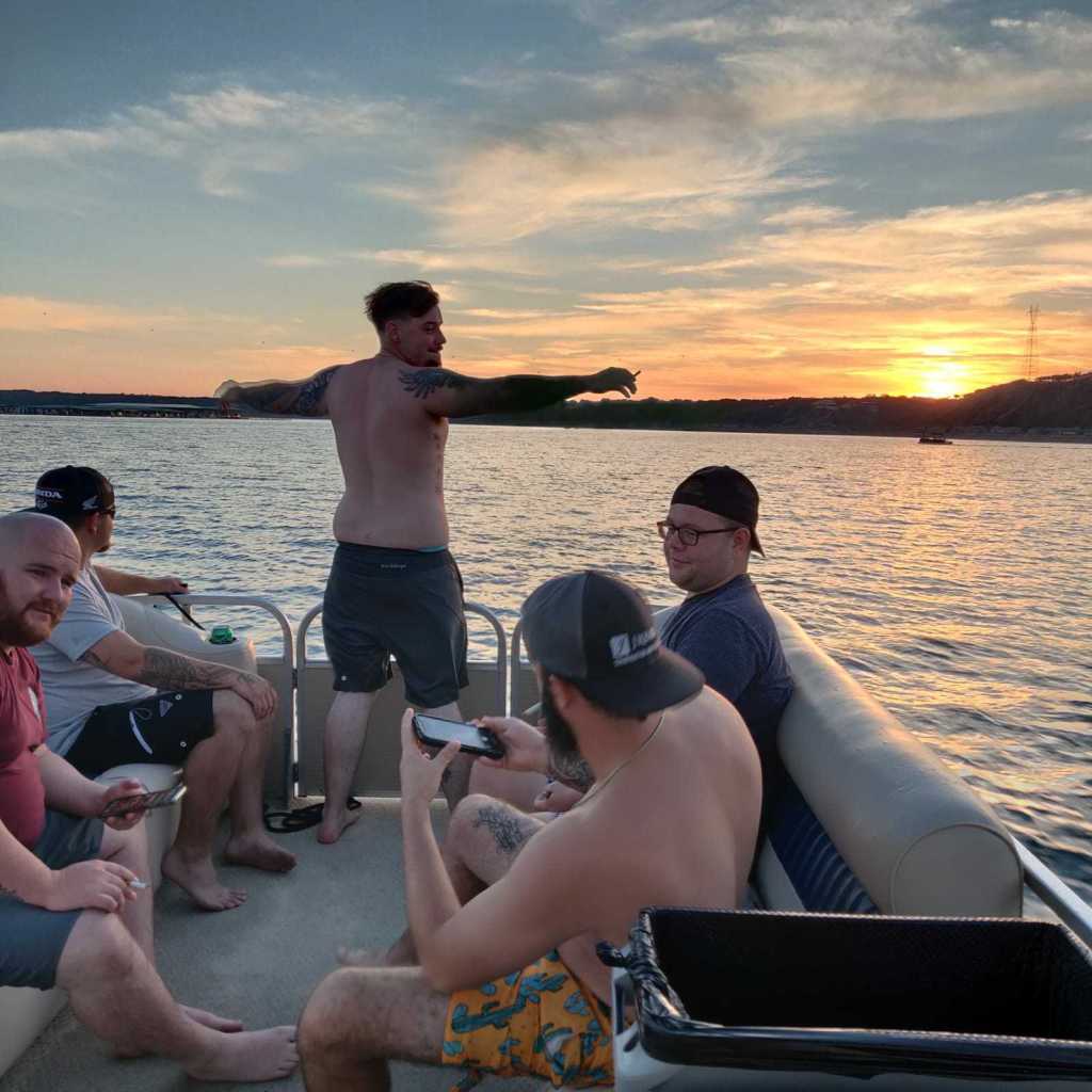 a group of people sitting in a boat on a body of water