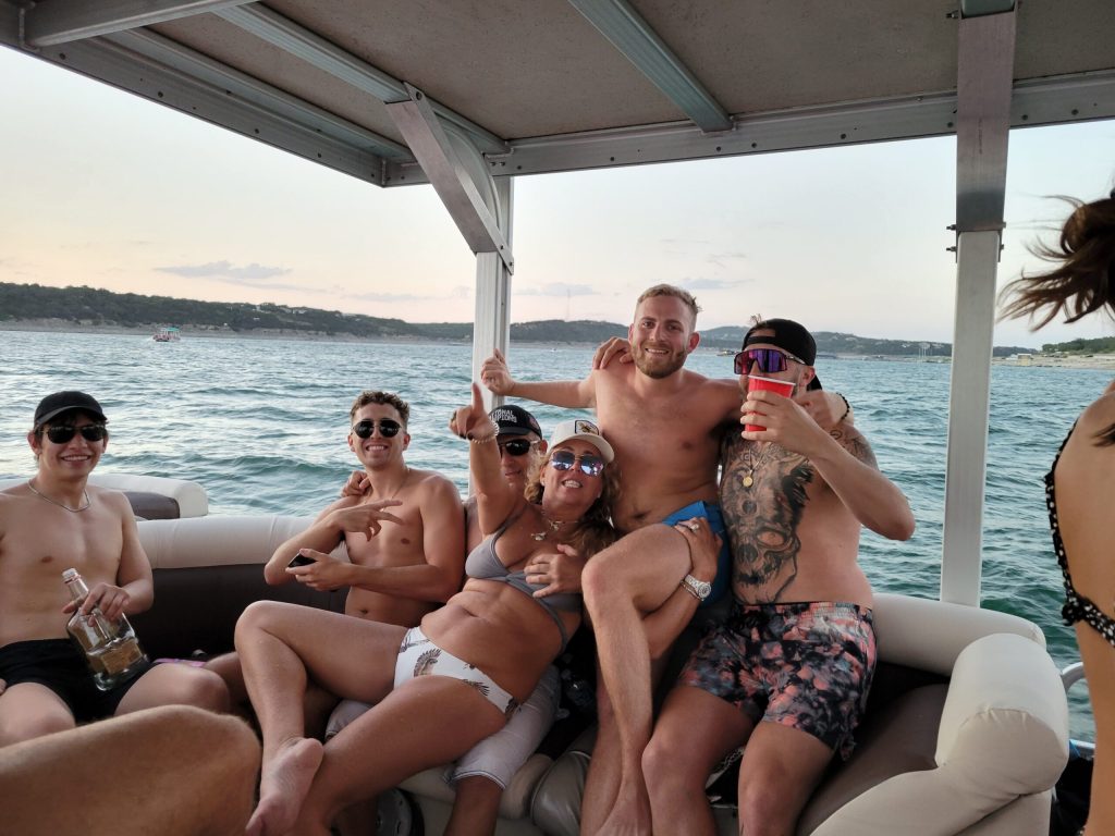 a group of people sitting next to a body of water