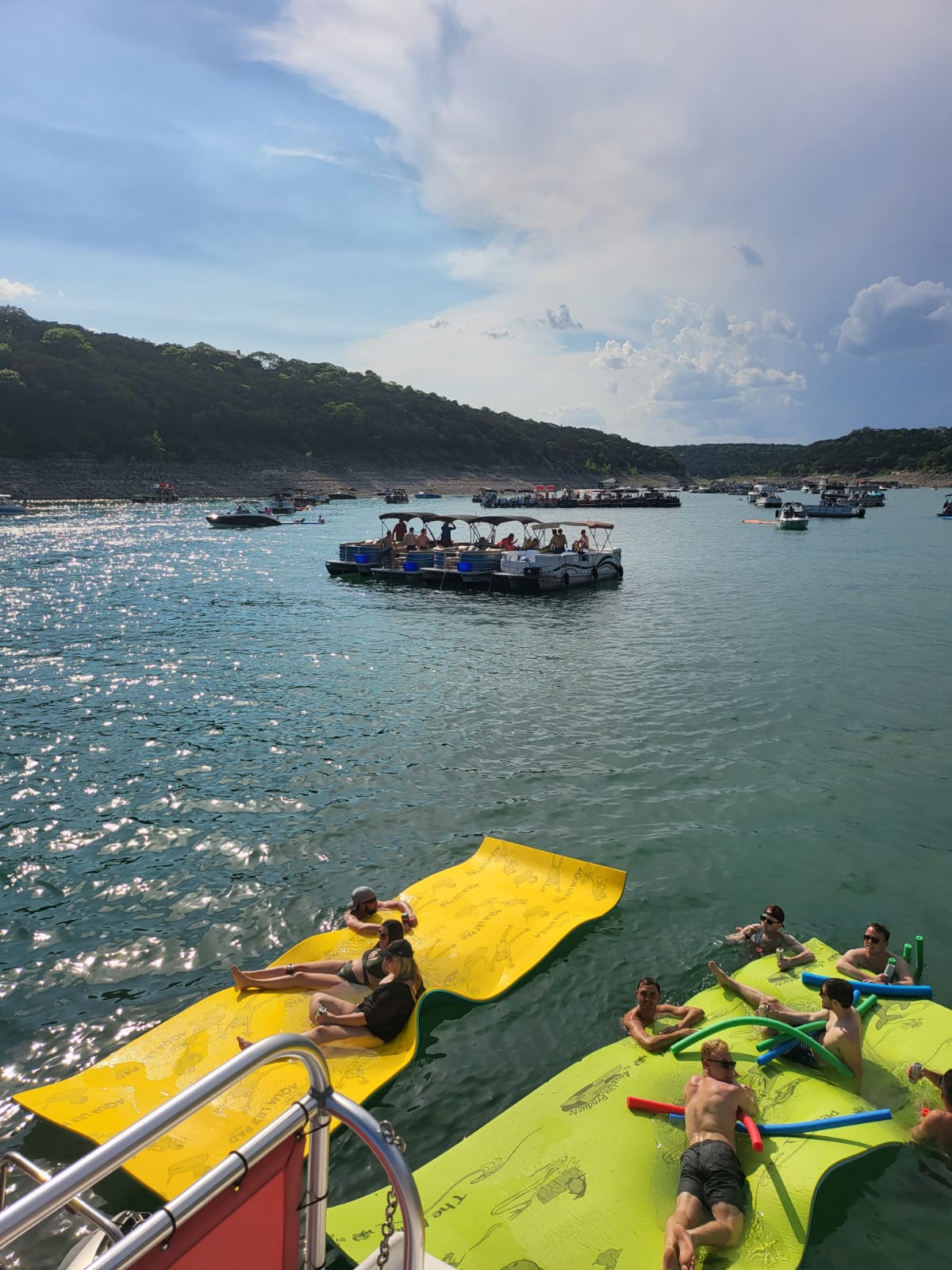 a boat floating along a river next to a body of water
